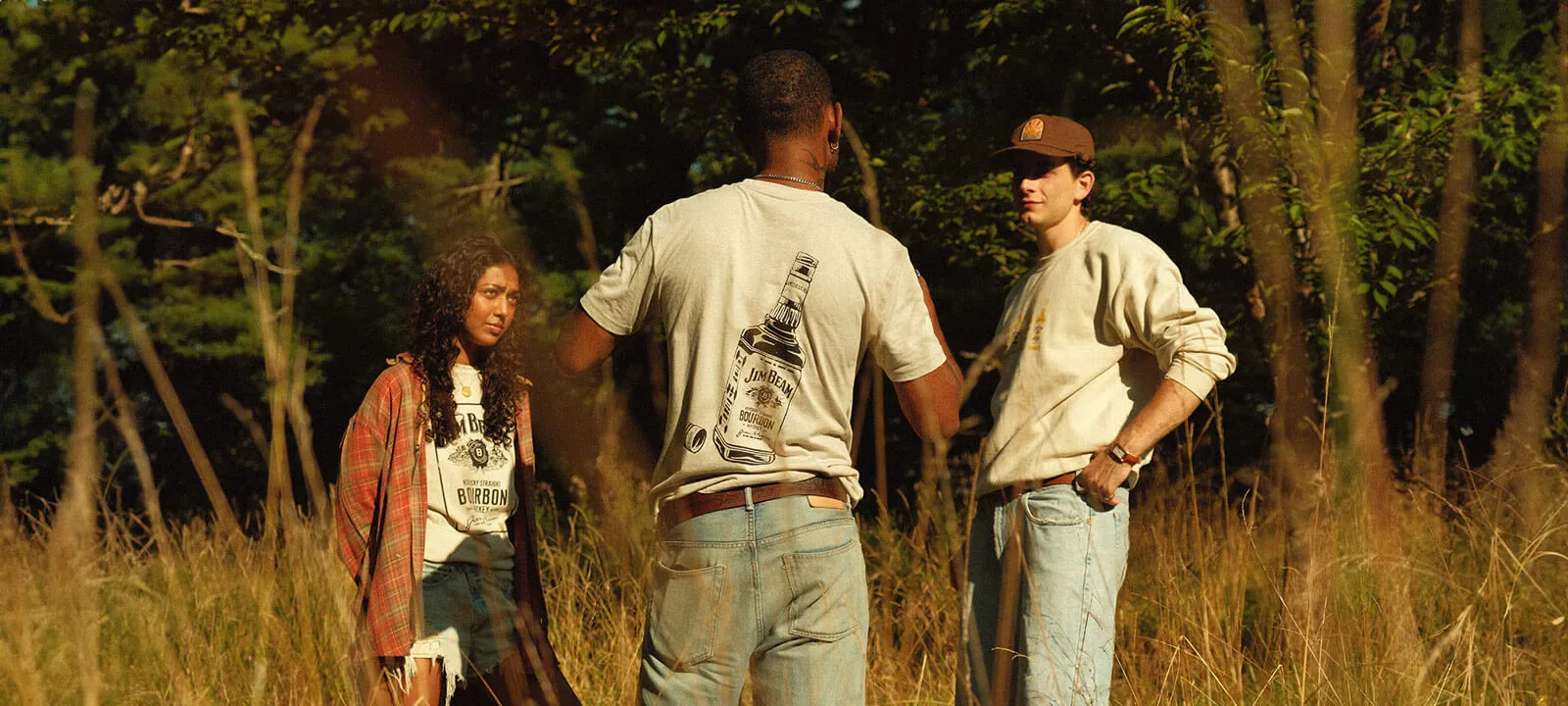 Young people in summer in the countryside with clothes from Jim Beam